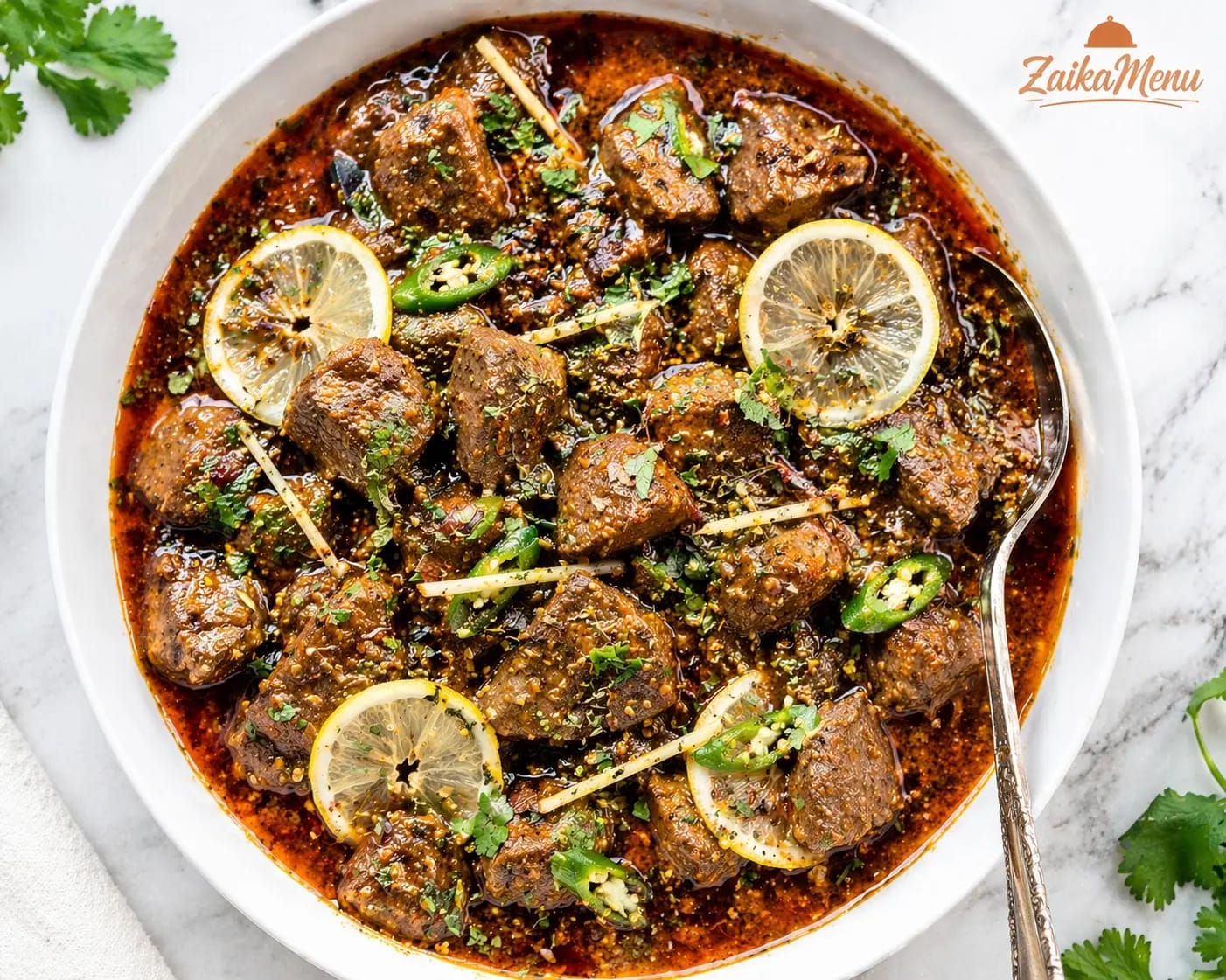 Close-up shot of Soft Masala Kaleji with lemon and green chili garnish - ZaikaMenu Guide